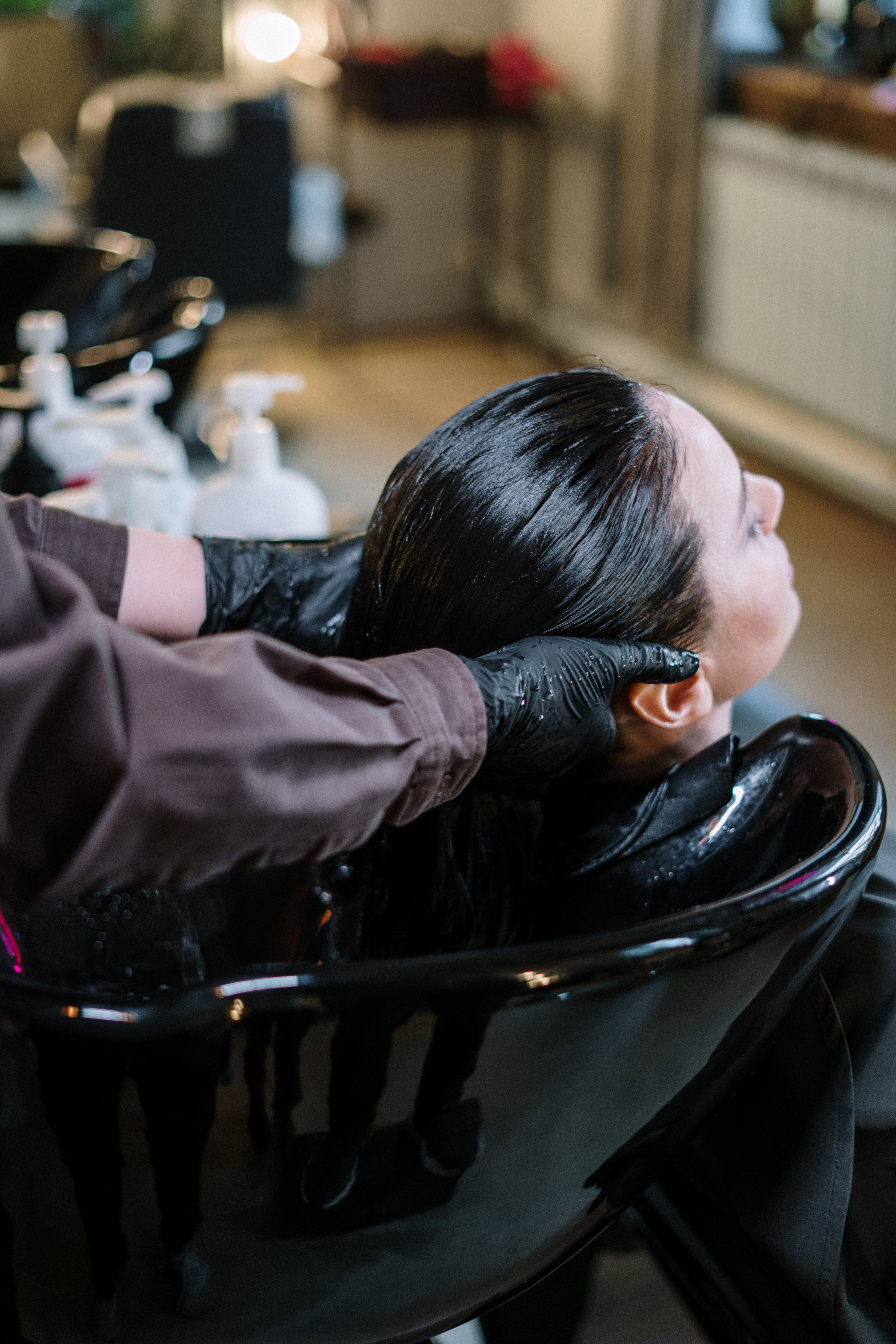 Professional hairstylist working on a client's hair in a salon and spa